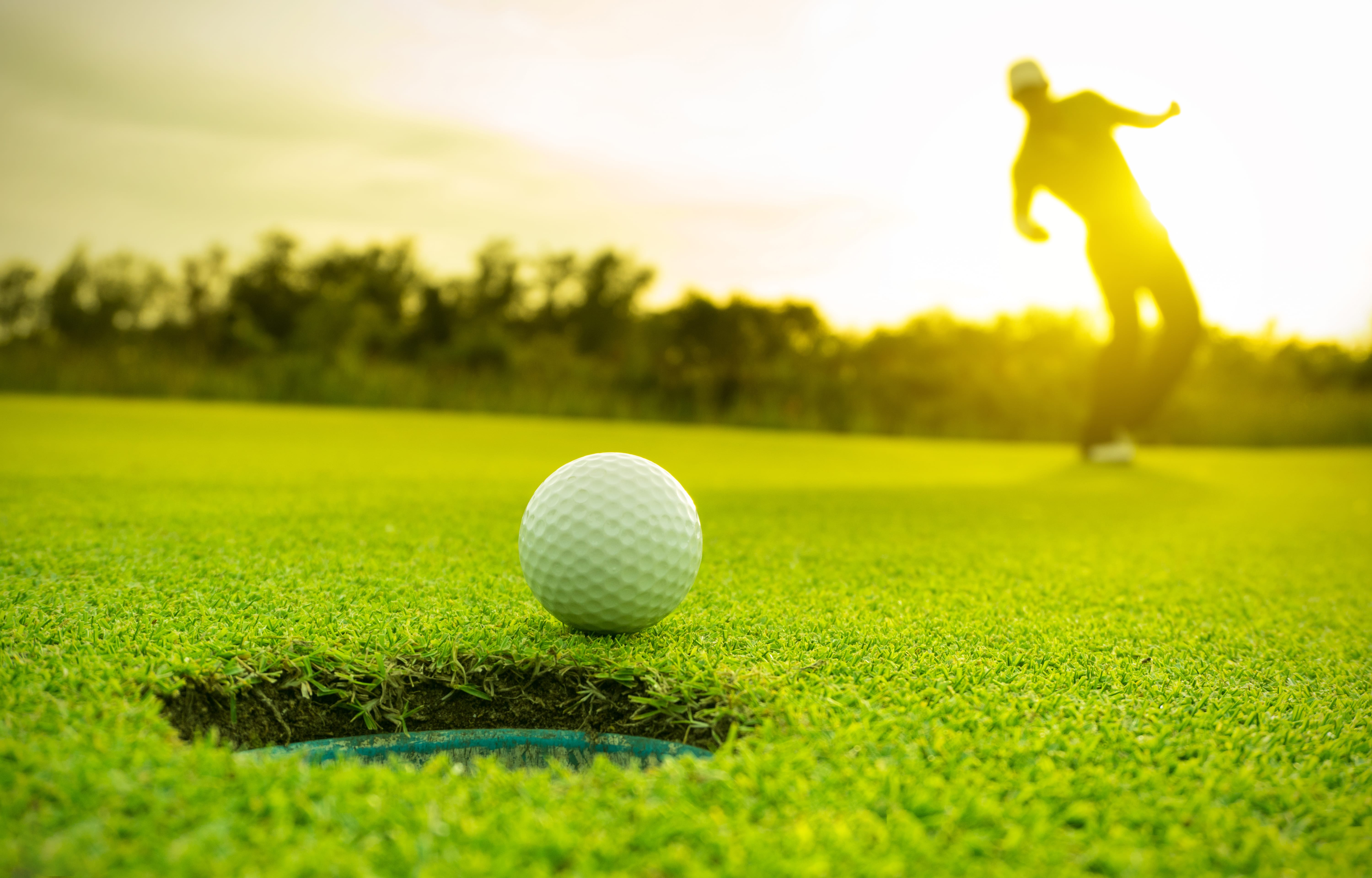 Golfer making a long putt on the green