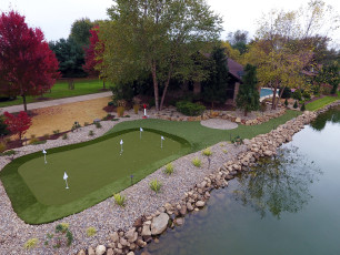 A beautiful backyard putting green installed by ForeverLawn NEO.
