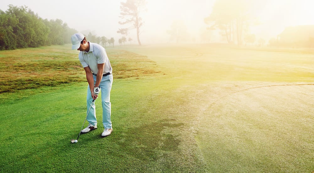 Golfer chipping onto the green