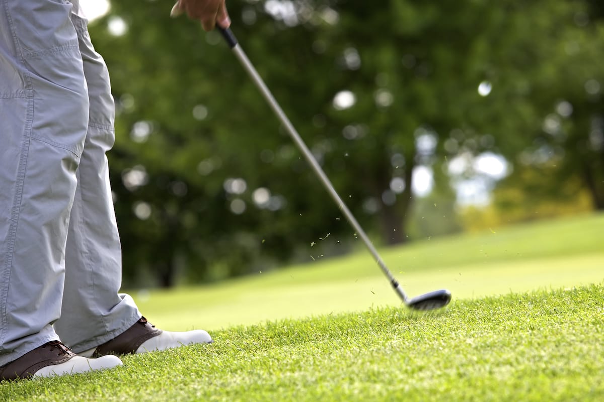 Golfer taking pitch shot