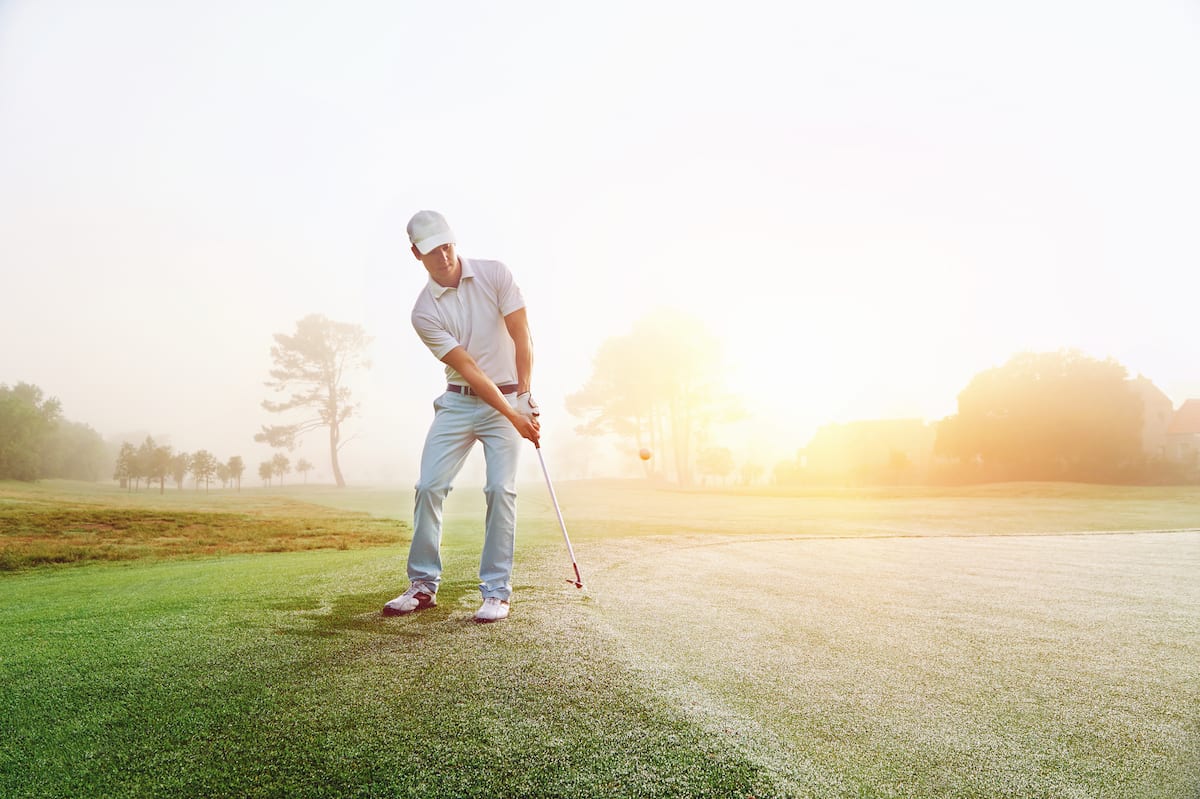 Golfer chipping the ball onto the green