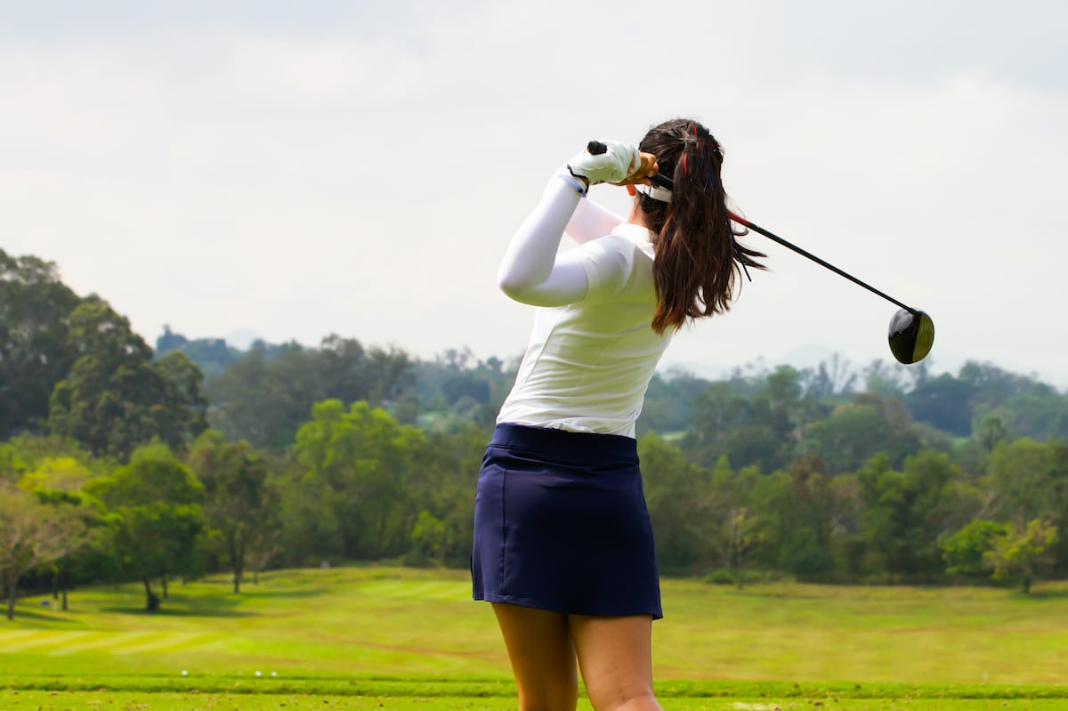 Female golfer hitting a draw and fade