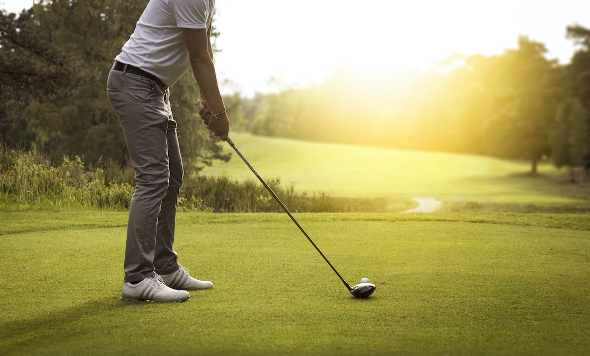 Golfer setting up the proper golf stance